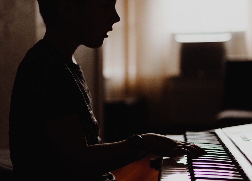 Young boy practicing piano